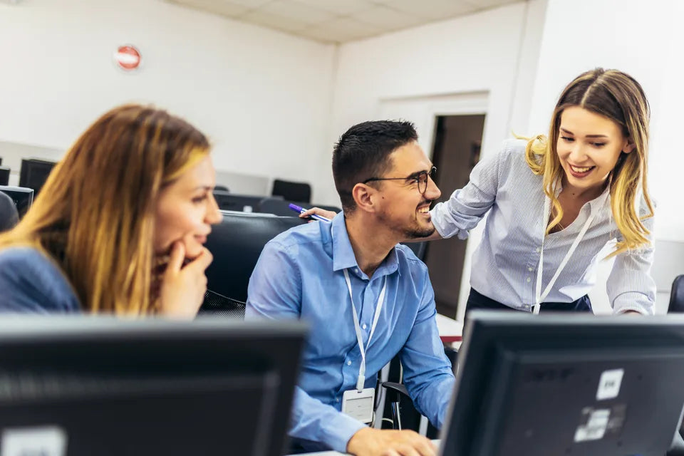 Students and an instructor working together at computers