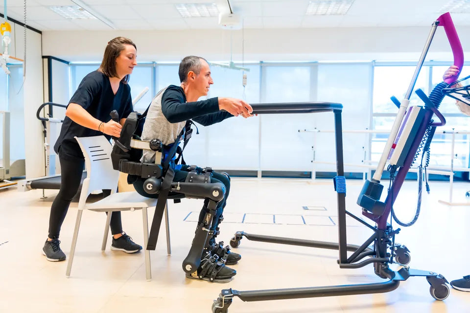 A person using assistive equipment with a professional nearby